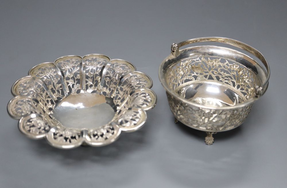 A Chinese pierced white metal flowerhead bowl, diameter 12.2cm, maker MT and a similar small swing-handled basket (2)